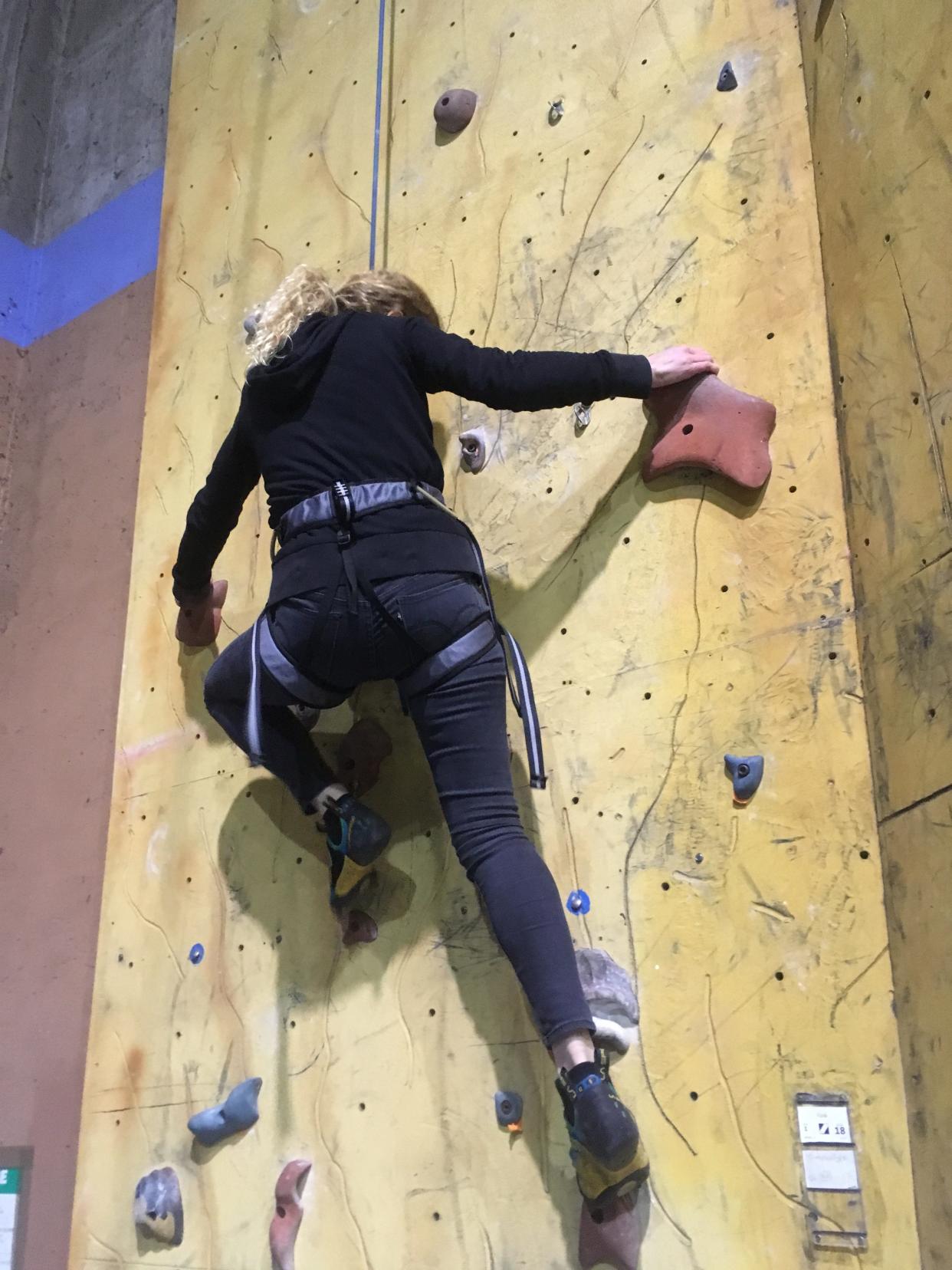 The author climbing in an indoor rock-climbing gym.