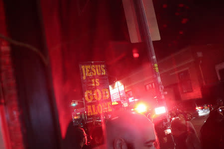 Demonstrators stand outside Catland Books during a ceremony hexing U.S. Supreme Court Justice Brett Kavanaugh in Brooklyn, New York, U.S., October 20, 2018. REUTERS/Shannon Stapleton