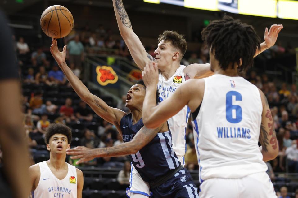 Memphis Grizzlies guard Ronaldo Segu (9) shoots against Oklahoma City Thunder guard Vit Krejci and forward Jaylin Williams (6) during the first half of an NBA summer league basketball game Wednesday, July 6, 2022, in Salt Lake City. (AP Photo/Jeff Swinger)