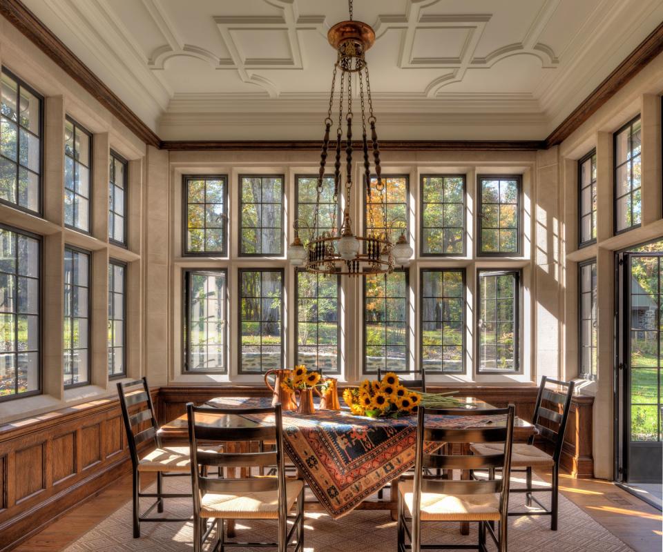 breakfast nook with sunflowers on table and windows all round