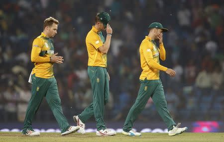 Cricket - South Africa v West Indies - World Twenty20 cricket tournament - Nagpur, India, 25/03/2016. (L-R) South Africa's David Miller, Chris Morris and captain Faf du Plessis walk off the field after they lost their match. REUTERS/Danish Siddiqui