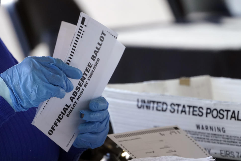 FILE - A worker at the Fulton County Board of Registration and Elections works to process absentee ballots at the State Farm Arena Monday, Nov. 2, 2020, in Atlanta. On Friday, Dec. 1, 2023, The Associated Press reported on stories circulating online incorrectly claiming a recent court filing revealed that 3,600 “duplicate” ballots were cast for Biden and illegally counted in Fulton County, Georgia during the 2020 election.(AP Photo/John Bazemore, File)