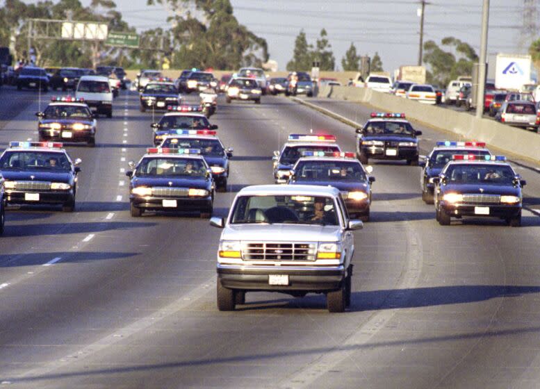 Caption:_ME.CHASE.8.0617.AS––BUENA PARK––California Highway _Patrol chase Al Cowlings, driving, and O.J. Simpson, hiding in _rear of white Bronco Friday on the 91 Freeway, just West of the I–_5 freeway. The chase ended in Simpson's arrest at his Brentwood _home. Mandatory Credit: AL SCHABEN/THE LOS ANGELES TIME