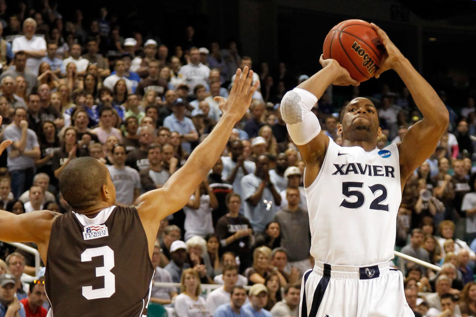 GREENSBORO, NC - MARCH 18: Tu Holloway #52 of the Xavier Musketeers shoots over C.J. McCollum #3 of the Lehigh Mountain Hawks in the second half during the third round of the 2012 NCAA Men's Basketball Tournament at Greensboro Coliseum on March 18, 2012 in Greensboro, North Carolina. (Photo by Mike Ehrmann/Getty Images)