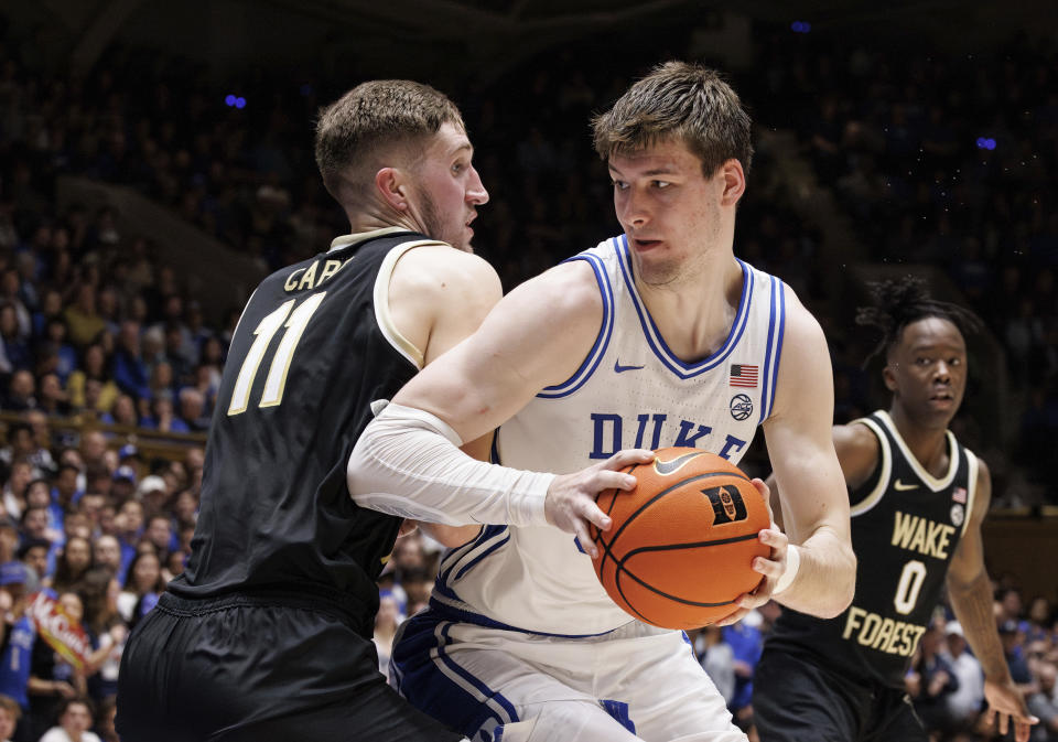 Duke's Kyle Filipowski, right, works in the post against Wake Forest's Andrew Carr (11) during the second half of an NCAA college basketball game in Durham, N.C., Monday, Feb. 12, 2024. (AP Photo/Ben McKeown)