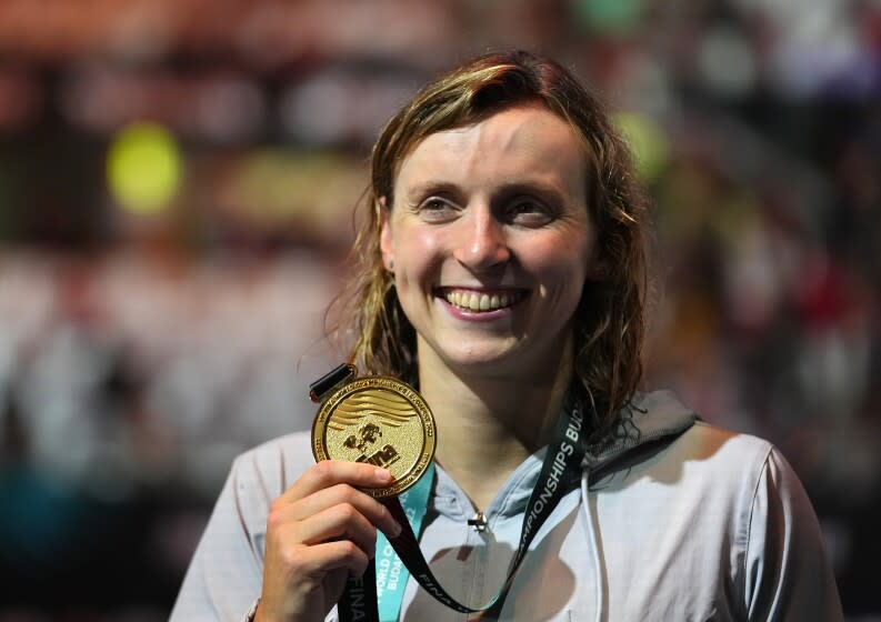 Gold medalist Katie Ledecky of the United States poses with her medal after the Women 800m Freestyle.