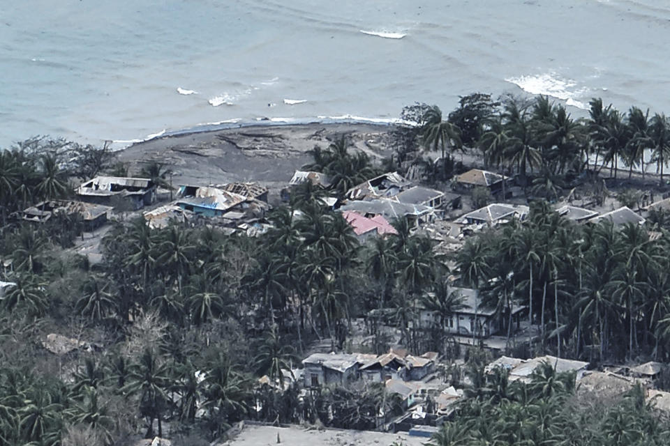 This photo provided by the Indonesian National Search and Rescue Agency (BASARNAS) shows a part of a village on Tagulandang island covered by ash from eruptions of Mountt Ruang in the Sulawesi island, Indonesia, Friday, April 19, 2024. More people living near an erupting volcano on Indonesia's Sulawesi Island were evacuated on Friday due to the dangers of spreading ash, falling rocks, hot volcanic clouds and the possibility of a tsunami. (National Search and Rescue Agency via AP)