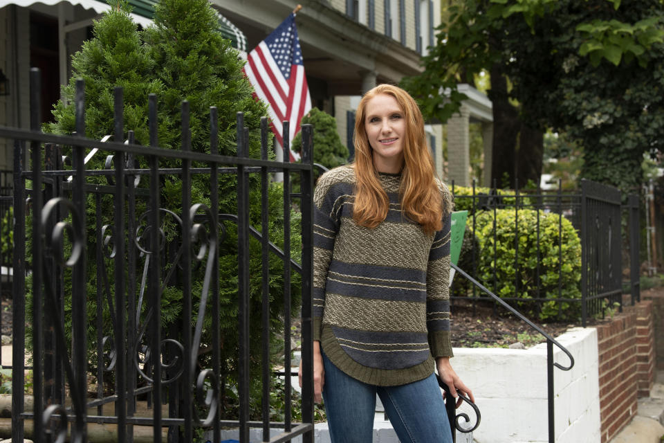 American Airlines flight attendant Allie Malis stands outside her home on Friday, Sept. 25, 2020, in Washington. About 40,000 workers in the airline industry are facing layoffs on Thursday, Oct. 1, unless Congress comes up with another aid package. “At this point I don’t have a Plan B,” she said, pointing out that restaurant and other jobs that laid-off workers usually get to make it through a downturn don’t exist in this crisis. (AP Photo/Kevin Wolf)