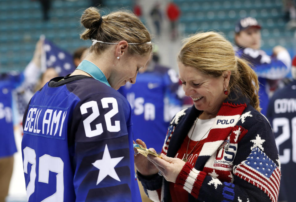 Kacey Bellamy shows her mother, Maura, her women's ice hockey gold medal on&nbsp;Feb. 22.