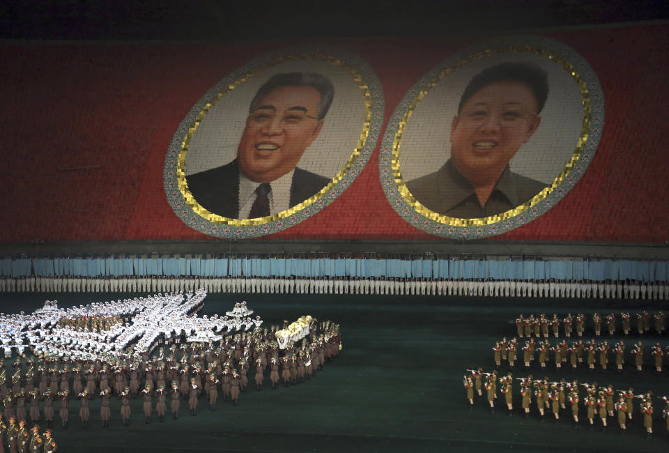 FILE - In this July 22, 2013, file photo, performers dance in front of portraits of late North Korean leaders Kim Il Sung, left, and Kim Jong Il in Pyongyang, North Korea. North Korea is bringing back one of its most iconic art forms - mass games performed by tens of thousands of people working in precise unison - to mark its 70th anniversary on Sunday, Sept. 9, 2018. The performance, which takes months if not years of intense preparation and training, is being called “Glorious Country” this year. (AP Photo/Wong Maye-E, File)