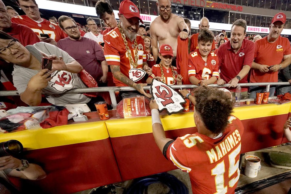 Kansas City Chiefs quarterback Patrick Mahomes signs autographs after an NFL football game against the Las Vegas Raiders Monday, Oct. 10, 2022, in Kansas City, Mo. The Chiefs won 30-29. (AP Photo/Charlie Riedel)