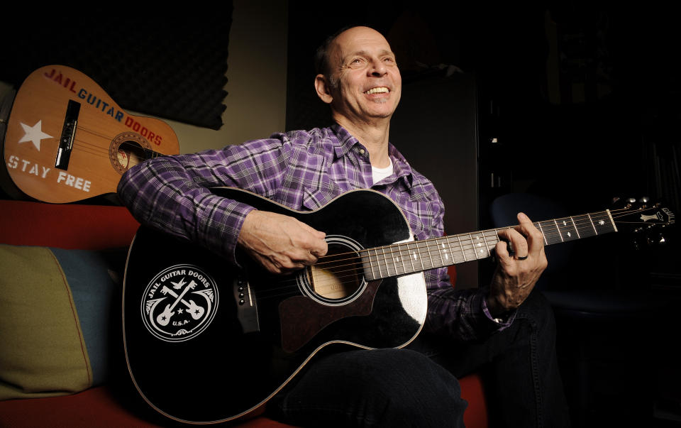 In this Jan. 16, 2012 photo, guitarist Wayne Kramer, founder of the band the MC5, plays one of the instruments that will be provided to jail inmates as part of the Jail Guitar Doors USA initiative at Kramer's recording studio in Los Angeles. The Jail Guitar Doors program provides instruments to inmates who are using music as a means of achieving rehabilitation. (AP Photo/Chris Pizzello)