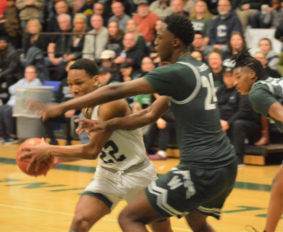 Griswold senior Jeff Souvenance makes his move against Weaver center Chris Wilson during the Wolverines' quarterfinal round win Monday at Griswold High School.