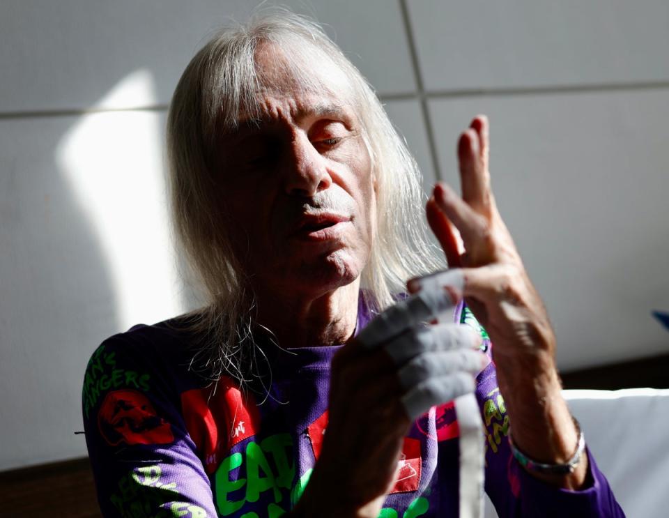 French urban climber Alain Robert, known as the 'French Spider-Man,' tapes his hands with bandages before he climbs the GT Capital building in Manil (EPA)