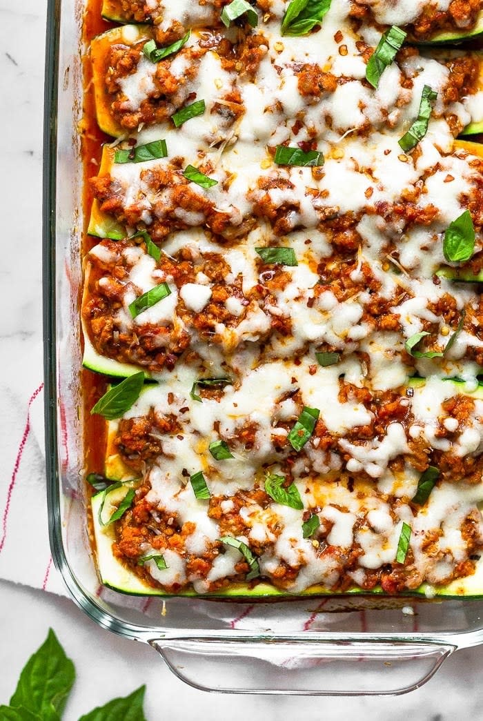 Zucchini pizza boats in a glass baking dish