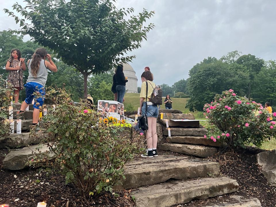 Jennifer Nelson, 25, of Plain Township looks at pictures of Raychel Sheridan during a vigil in her memory in Monument Park. "Whenever, I was having a bad day, she would cheer me up," said Nelson, who called Sheridan a "ray of sunshine" and a "very down-to-earth girl."