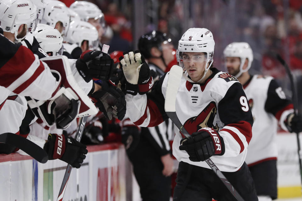 Arizona Coyotes right wing Clayton Keller high-fives teammates after scoring during the first period of an NHL hockey game against the Detroit Red Wings, Sunday, Dec. 22, 2019, in Detroit. (AP Photo/Carlos Osorio)