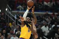 Los Angeles Lakers forward LeBron James, top, shoots as Los Angeles Clippers guard Terance Mann defends during the first half of an NBA basketball game Wednesday, Nov. 9, 2022, in Los Angeles. (AP Photo/Mark J. Terrill)