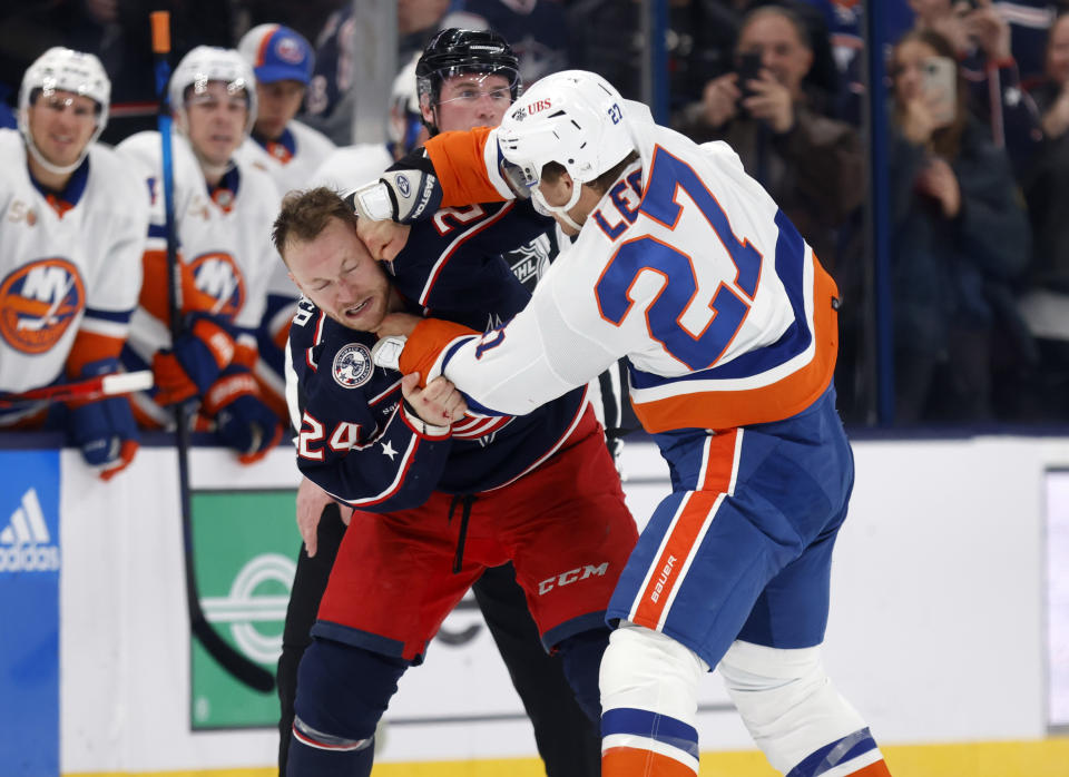 Columbus Blue Jackets forward Mathieu Olivier, left, and New York Islanders forward Anders Lee fight during the second period of an NHL hockey game in Columbus, Ohio, Friday, Nov. 25, 2022. (AP Photo/Paul Vernon)