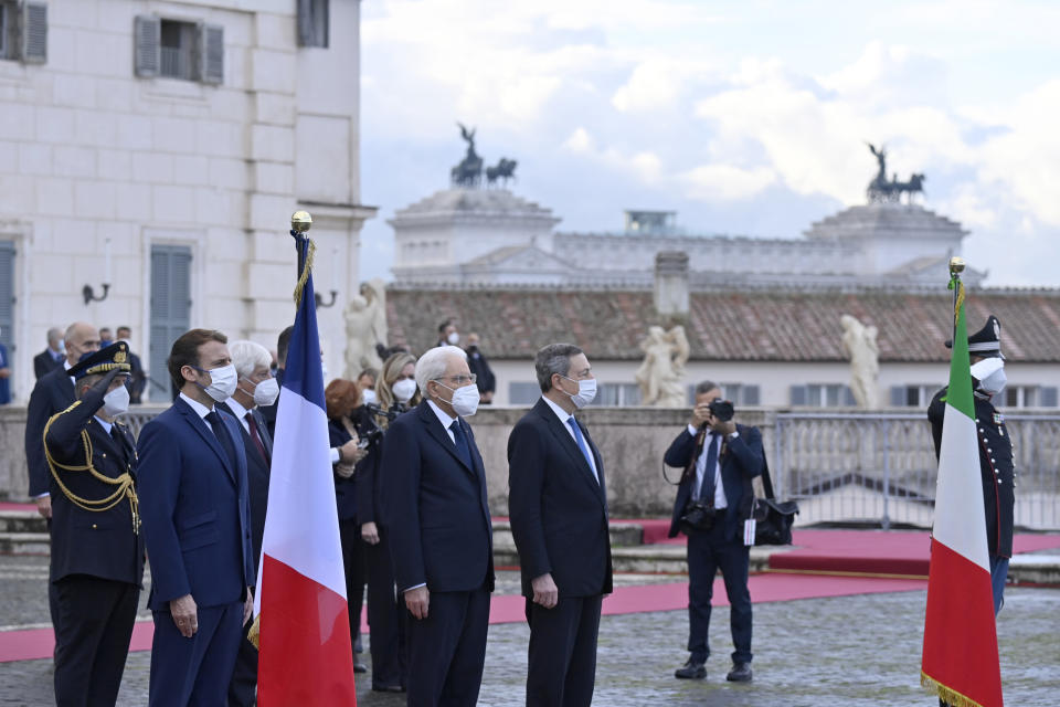 From left, France's President Emmanuel Macron, Italy's President Sergio Mattarella and Italy's Prime Minister Mario Draghi attend a ceremony after the signing of the Franco-Italian Quirinal Treaty at the Quirinale presidential palace in Rome, Friday, Nov. 26, 2021. (Alberto Pizzoli / Pool photo via AP)