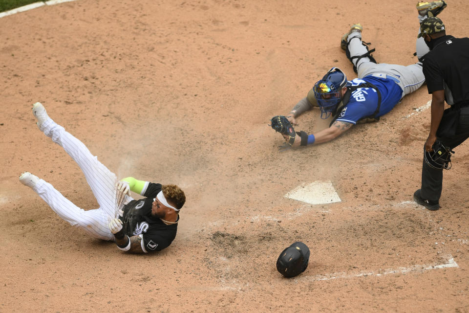 Chicago White Sox's Yoan Moncada (10) gets tagged out at home plate by Kansas City Royals catcher Cam Gallagher during the ninth inning of a baseball game Sunday, May 16, 2021, in Chicago. (AP Photo/Paul Beaty)