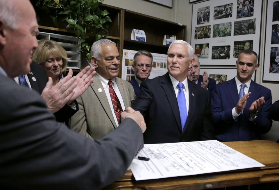 Republican Vice President Mike Pence shakes hands with New Hampshire Secretary of State Bill Gardner, left, after filing for President Donald Trump to be listed on the New Hampshire primary ballot, Thursday, Nov. 7, 2019, at the Secretary of State's office in Concord, N.H. (AP Photo/Charles Krupa)