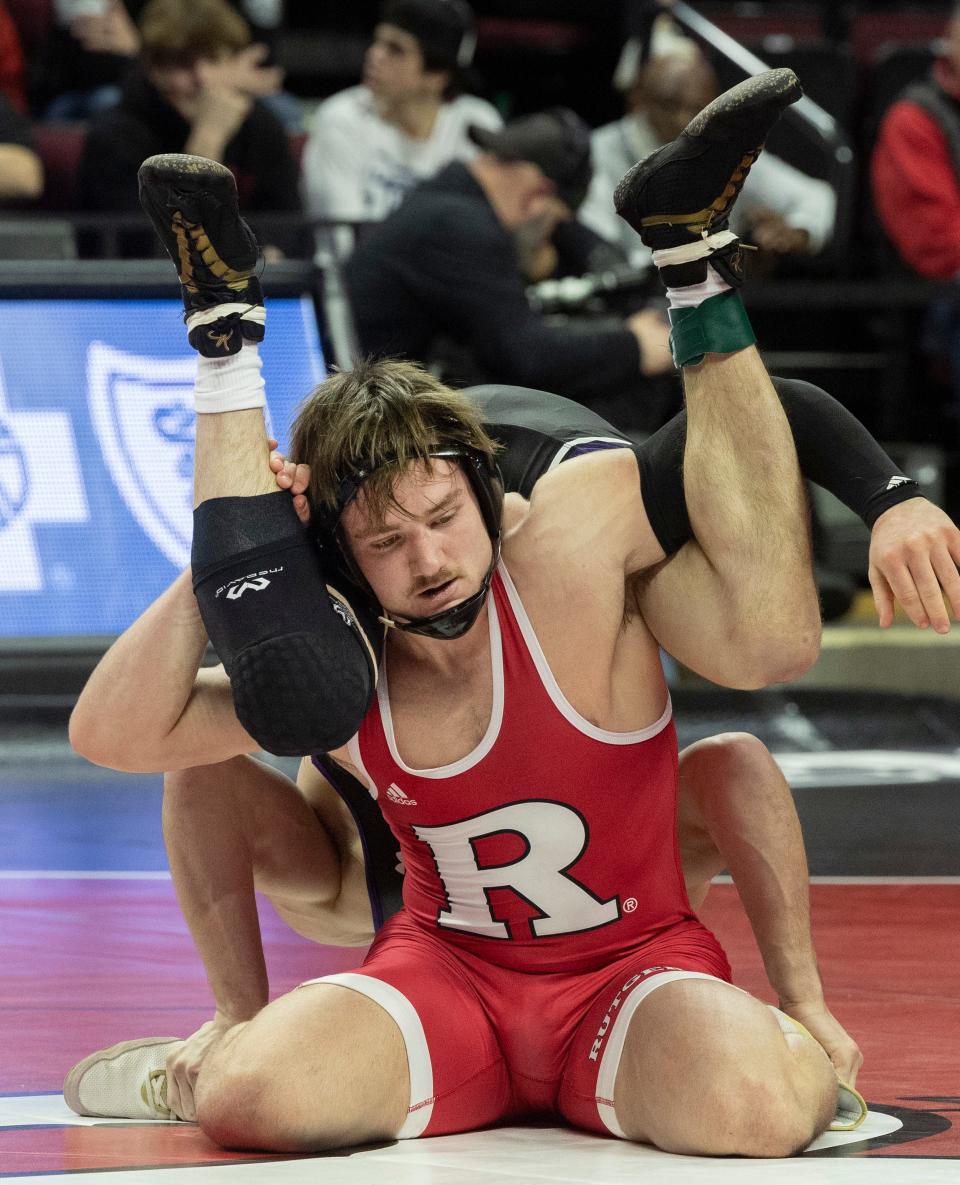 Rutgers' freshman Brian Soldano (center facing the camera) recorded the Scarlet Knights' first win in their 28-6 defeat to Northwestern Sunday with a 9-5 victory over Evan Bates.