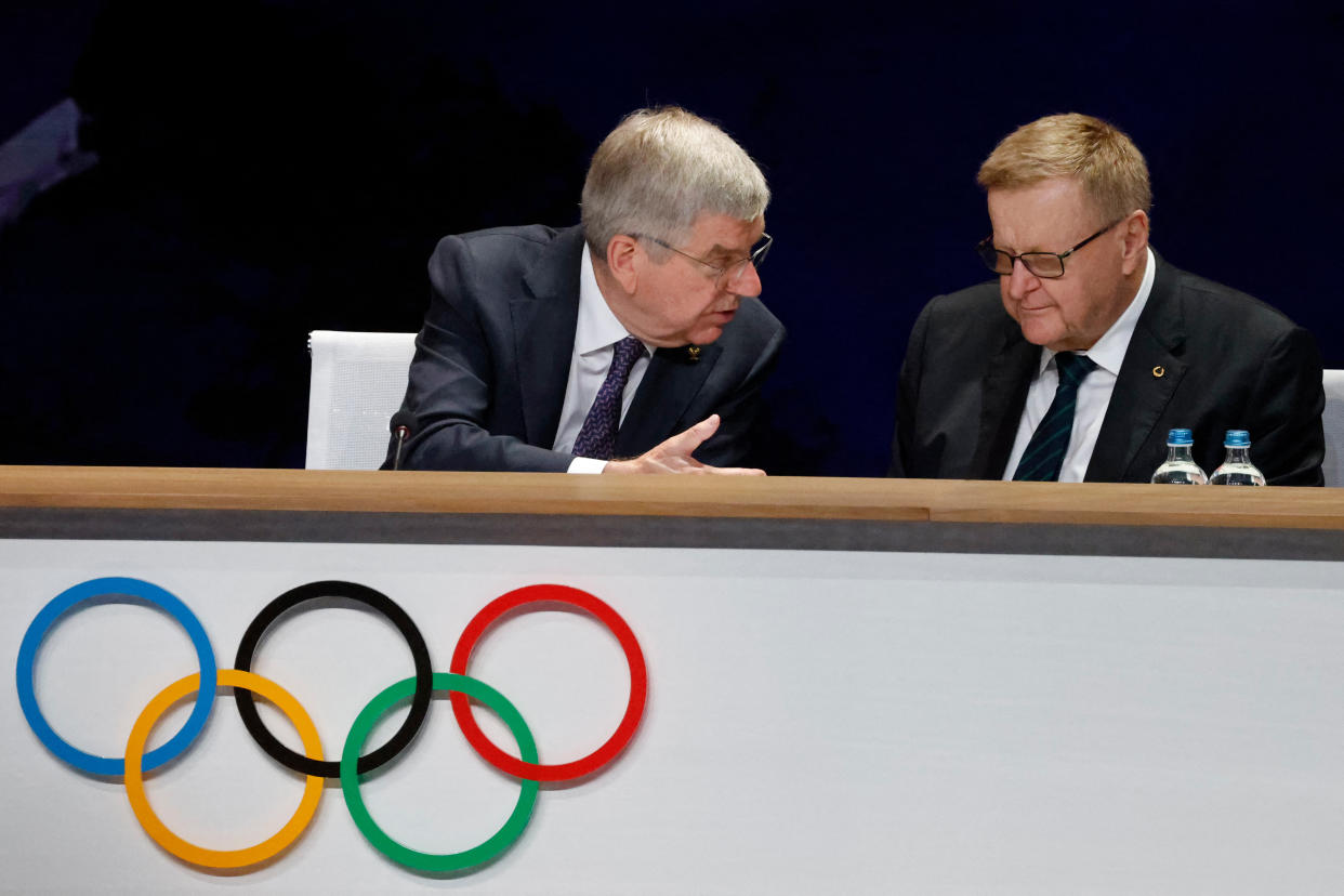 International Olympic Committe (IOC) President Thomas Bach (L) talks to IOC member John Coates during the 142nd session of the IOC in Paris on July 24, 2024, ahead of the Paris 2024 Olympic Games. (Photo by Ludovic MARIN / AFP) (Photo by LUDOVIC MARIN/AFP via Getty Images)