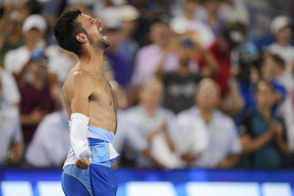 Novak Djokovic, of Serbia, rips his shirt as he celebrates after his win against Carlos Alcaraz, of Spain, in the men's singles final of the Western & Southern Open tennis tournament, Sunday, Aug. 20, 2023, in Mason, Ohio. (AP Photo/Aaron Doster)