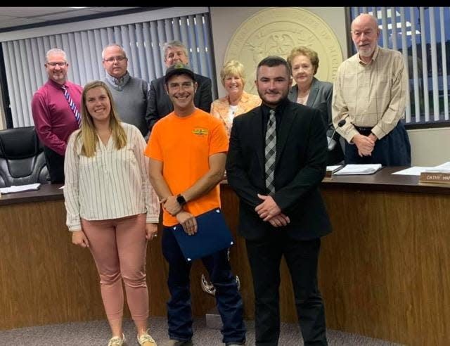 Algonac City Councilman Jake Skarbek, front right, stands with a group of officials and other residents near the council dais in Algonac.