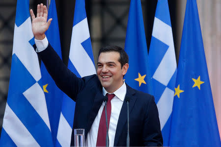 Greek Prime Minister Alexis Tsipras, wearing a tie, waves before a speech at the parliamentary group of Syriza and Independent Greeks in Athens, Greece June 22, 2018. REUTERS/Costas Baltas