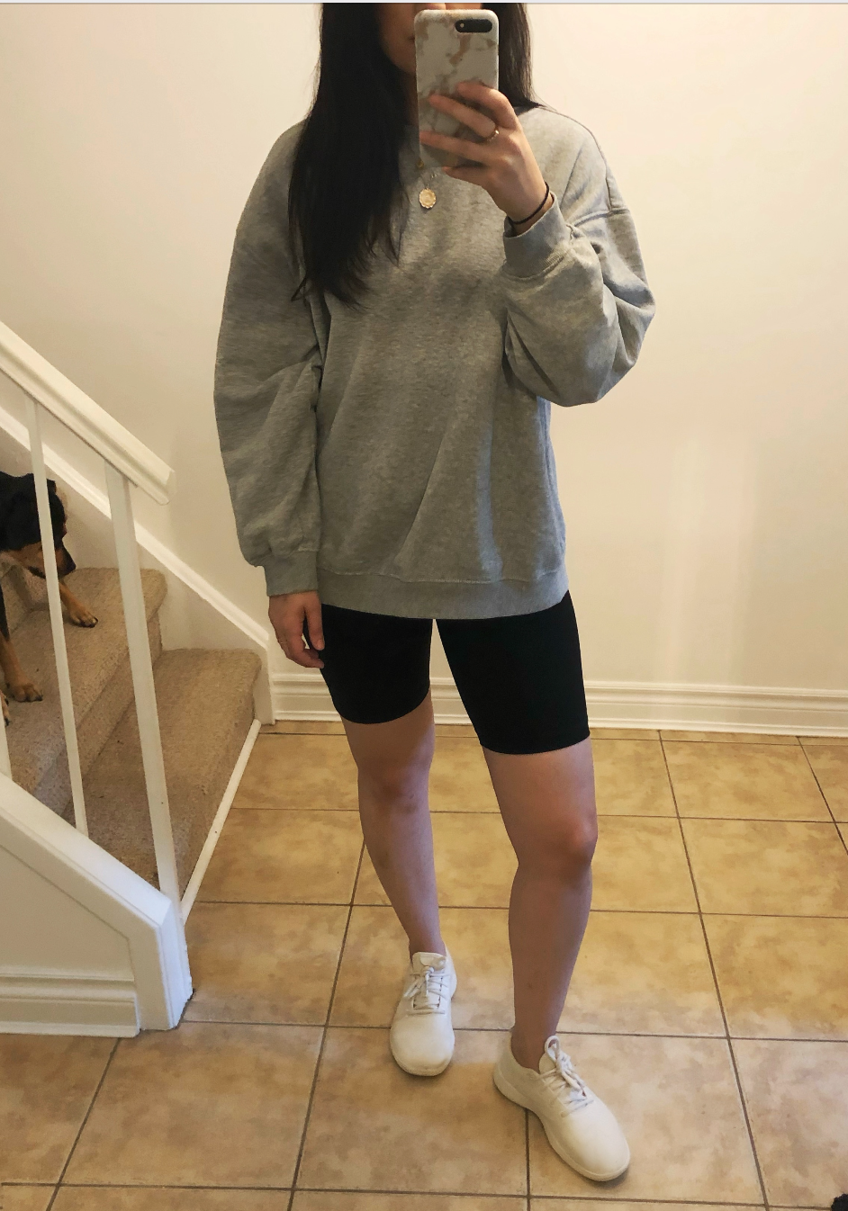 The Perform Bike Short in Black with an H&M oversized sweatshirt, Allbirds sneakers and Beagle/Rottweiler puppy. 