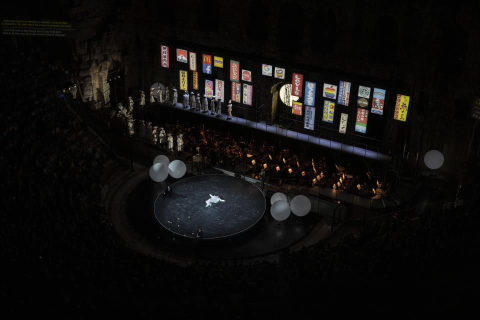 Italian tenor Andrea Care lies on the stage at the Odeon of Herodes Atticus during a performance of "Madame Butterfly" in Athens, on Thursday, June 1, 2023. The annual arts festival in Athens and at the ancient theater of Epidaurus in southern Greece is dedicated this year to the late opera great Maria Callas who was born 100 years ago. (AP Photo/Petros Giannakouris)