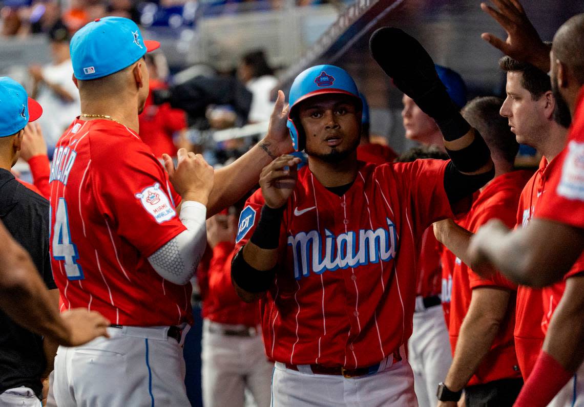 Miami Marlins second baseman Luis Arraez (3) celebrates with his teammates after scoring a run against the Chicago Cubs in the first inning of an MLB game at loanDepot park on Saturday, April 29, 2023, in Miami, Fla.
