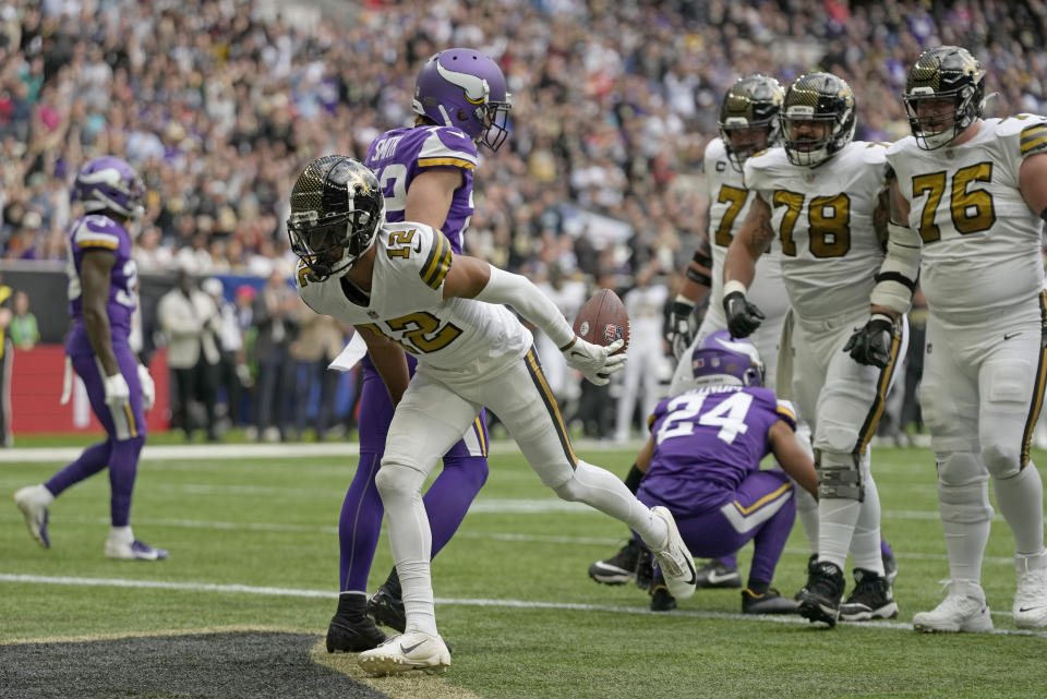 New Orleans Saints wide receiver Chris Olave (12) scores a touchdown during the second quarter of an NFL match between Minnesota Vikings and New Orleans Saints at the Tottenham Hotspur stadium in London, Sunday, Oct. 2, 2022. (AP Photo/Frank Augstein)