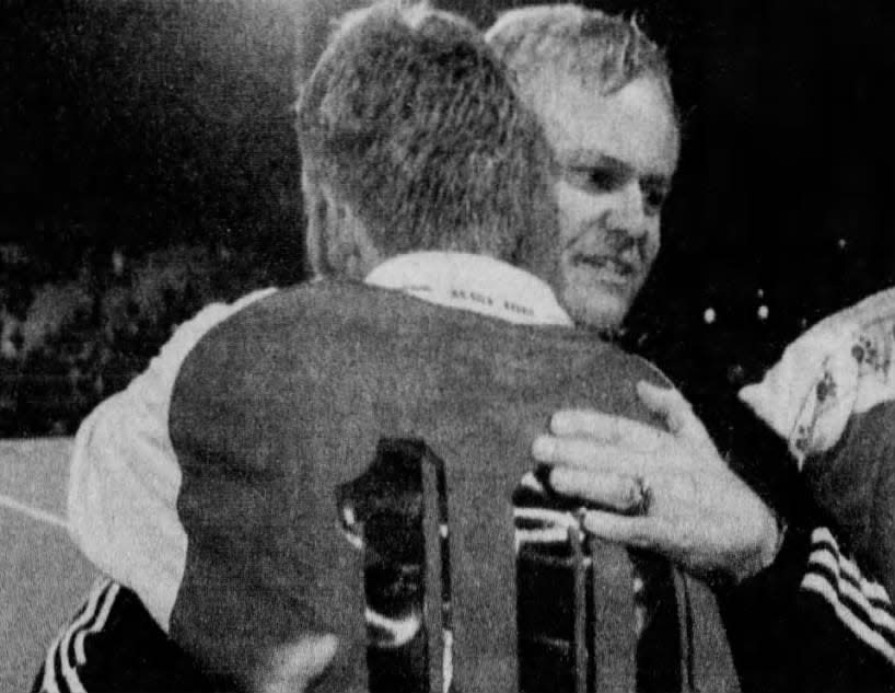Bridgewater-Raritan coach Rick Szeles hugs Julio Oliva after the team won a share of the state soccer championship on Friday, Nov. 20, 1998.