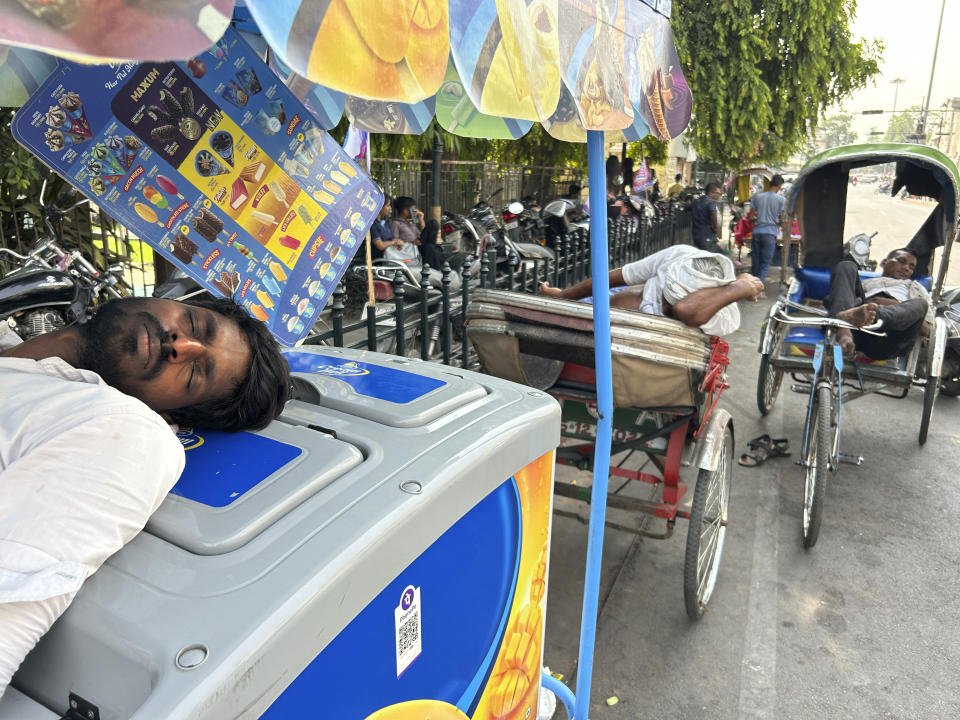 An ice cream vendor and rickshaw pullers sleep as severe heat grips Lucknow, India, Saturday, May 18, 2024. Swathes of northwest India sweltered under scorching temperatures on Saturday, with the capital New Delhi under a severe weather alert as extreme temperatures strike parts of the country. (AP Photo/Rajesh Kumar Singh)