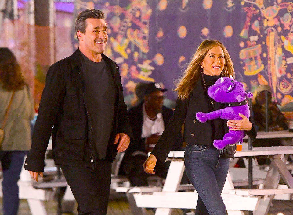 <p>Jon Hamm and Jennifer Aniston smile while filming scenes for <em>The Morning Show</em> at New York City's Coney Island on Sept. 28.</p>