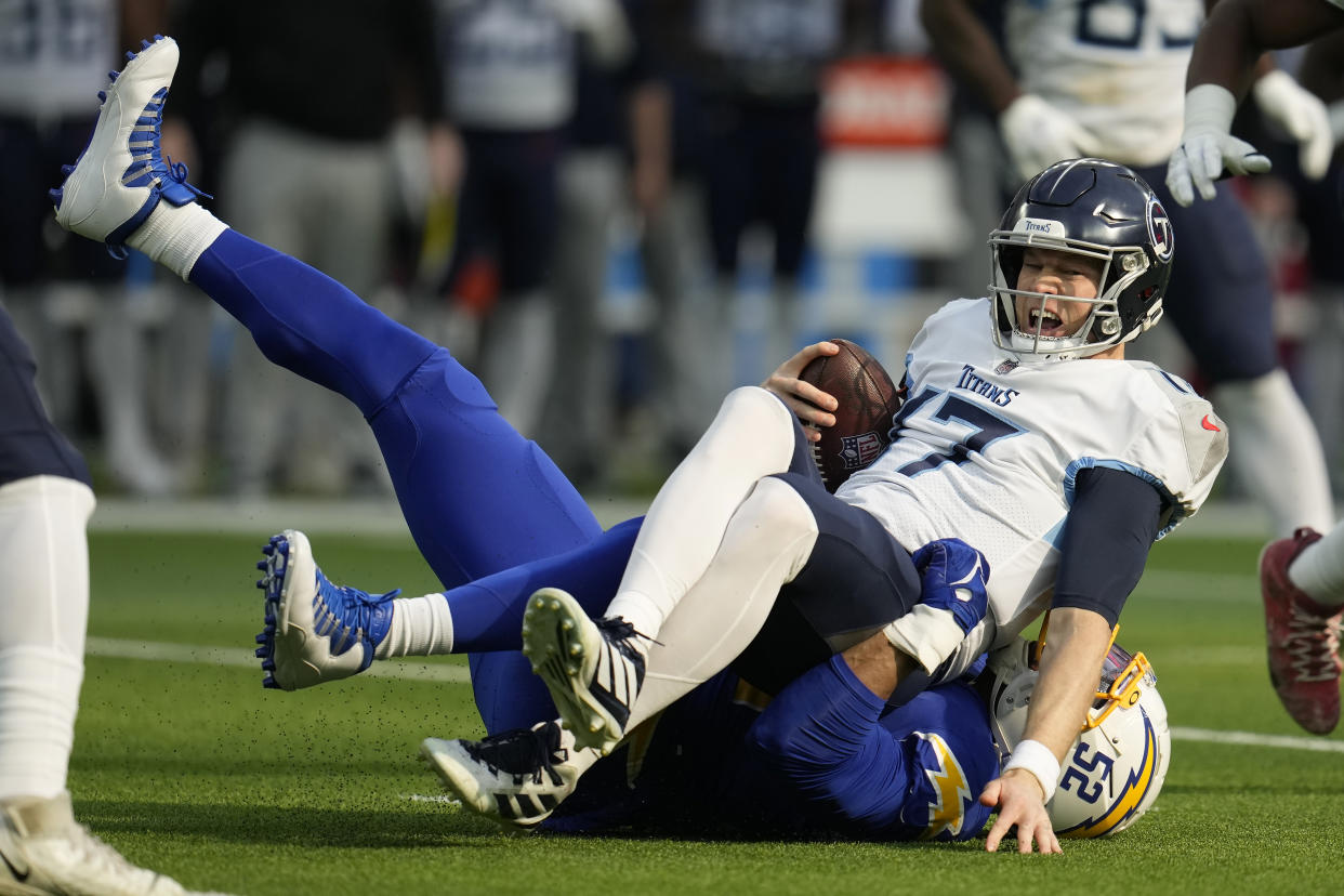 Tennessee Titans quarterback Ryan Tannehill (17) is tackled by Los Angeles Chargers linebacker Khalil Mack. (AP Photo/Marcio Jose Sanchez)