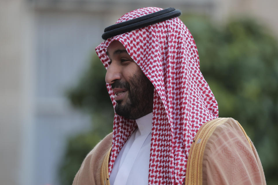 Saudi Crown Prince Mohammed bin Salman reaches out to shake hands with French President Emmanuel Macron as he arrives for a dinner at the Elysee Palace in Paris, Thursday July 28, 2022. French President Emmanuel Macron welcomed Saudi Crown Prince Mohammed bin Salman to his presidential palace and offer him dinner, marking another step in the Saudi leader's diplomatic rehabilitation less than four years after the killing of writer and critic Jamal Khashoggi. (AP Photo/Lewis Joly)