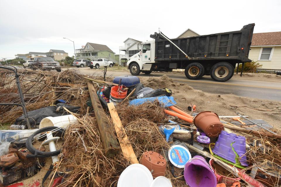 Crews and residents continue to clean up along East Beach Drive Thursday, Aug. 20, 2020, after Hurricane Isaias in Oak Island. STARNEWS FILE PHOTO