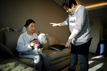 Kang Sung-il, a pet funeral manager, and his wife Ham Jin-seon play with their pet dog Sancho at his home in Incheon, South Korea, January 15, 2019. REUTERS/Kim Hong-Ji