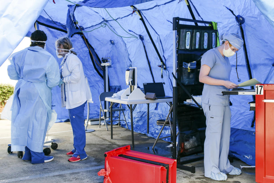 Nurses from Rush Health Systems in Meridian, Miss., set up a triage area to help keep too many people from entering the emergency room area at the hospital Tuesday, March 31, 2020. Rush wants the public to know that this is not a COVID-19 drive-through testing sight. (Paula Merritt/The Meridian Star via AP)