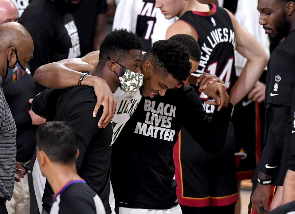 Giannis Antetokounmpo #34 of the Milwaukee Bucks exits the game after an injury during the second quarter against the Miami Heat in Game Four of the Eastern Conference Second Round 