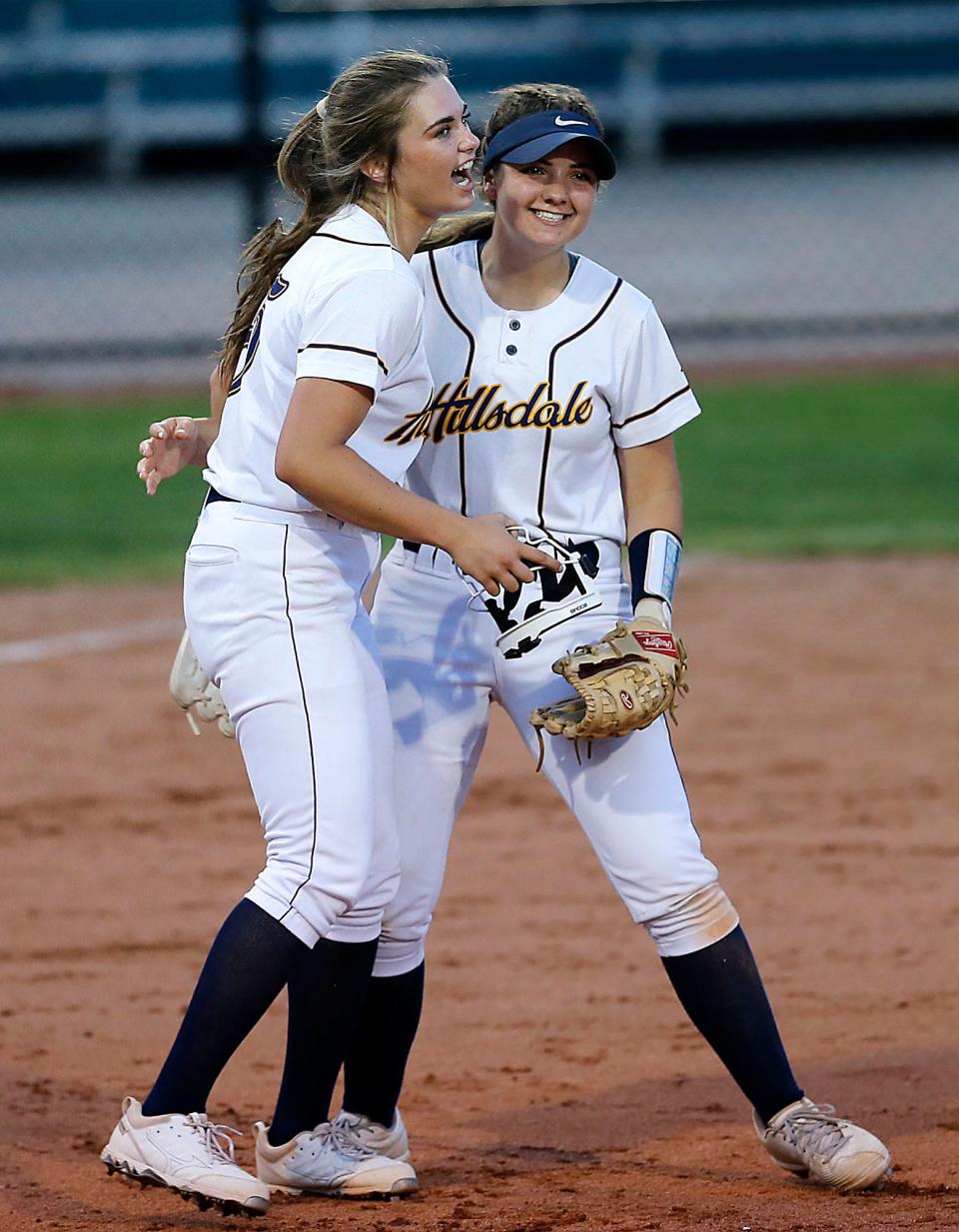 Hillsdale High School's Taylor Morgan, left, and Mollie Goon celebrate the 6-3 win over Loudonville High School during their OHSAA Division IV District Championship game Thursday, May 19, 2022 at Akron Firestone Stadium. TOM E. PUSKAR/TIMES-GAZETTE.COM