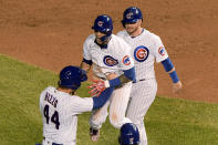 Chicago Cubs' Javier Baez, middle, celebrates with Anthony Rizzo (44) and Ian Happ (8) after driving in the winning run during the 10th inning against the Cleveland Indians in a baseball game Wednesday, Sept. 16, 2020, in Chicago. The Cubs won 3-2. (AP Photo/Mark Black)