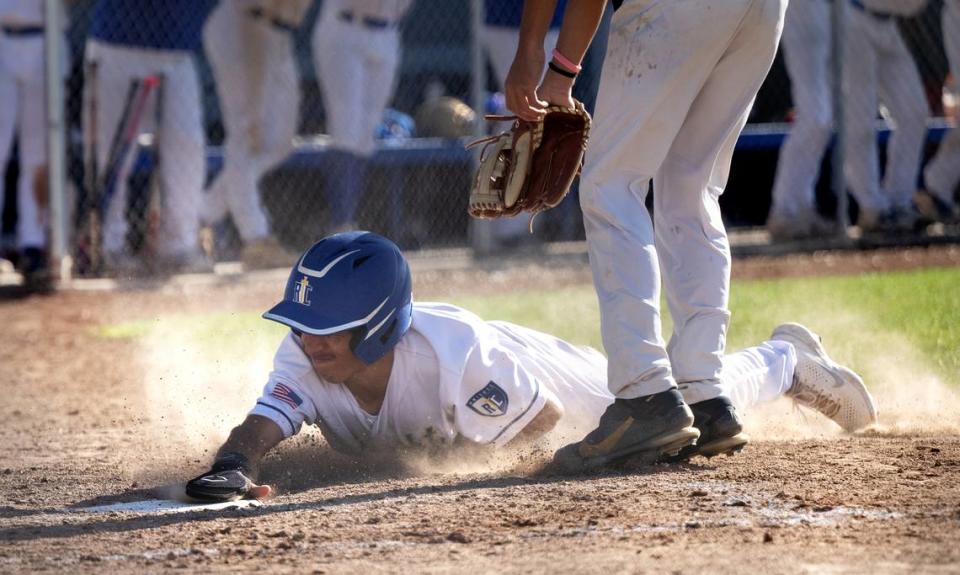 Ripon Christian’s Kayden Anderson steals home on a wild pitch during the Sac-Joaquin Section Division VI playoff game with Millennium of Tracy in Ripon, Calif., Wednesday, May 8, 2024.