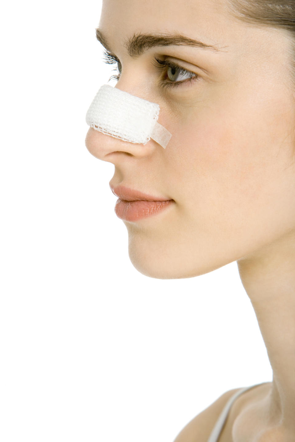 A woman is seen from a profile view wearing a nasal bandage