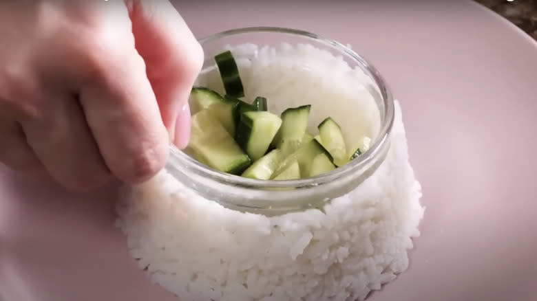 hand holding bowl in rice 