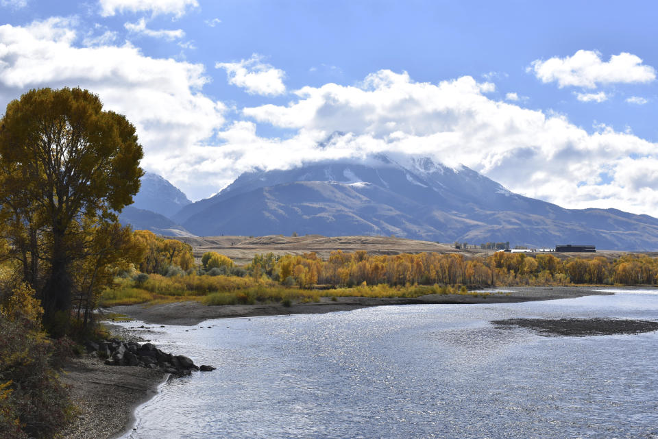 Emigrant Peak is seen rising above the Paradise Valley and the Yellowstone River near Emigrant, Mont., Monday, Oct. 8, 2018. U.S. Interior Sec. Ryan Zinke has announced a 20-year ban on new mining claims on public lands in Montana, north of Yellowstone National Park. (AP Photo/Matthew Brown)